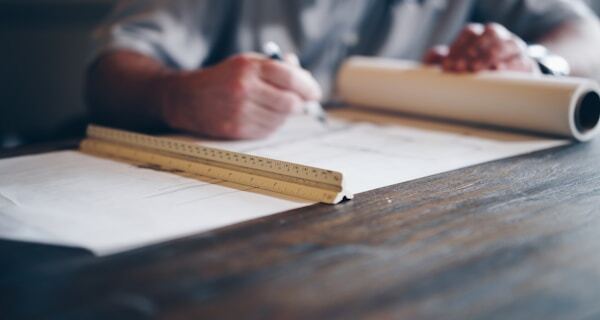 Engineer drafting technical blueprint
